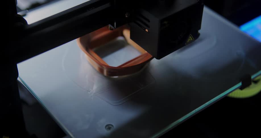 A 3d printer creates a brown object