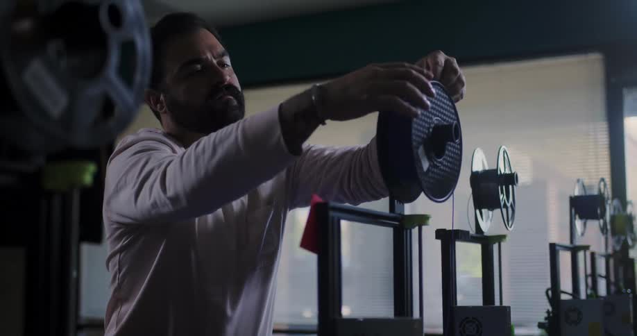 A man examines a film canister