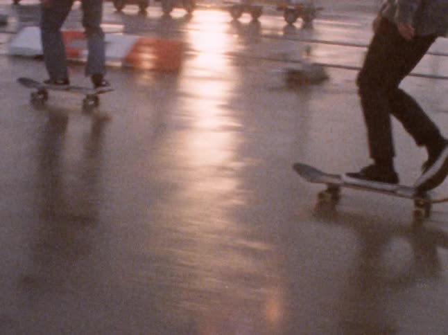 Four teens skateboarding outdoors