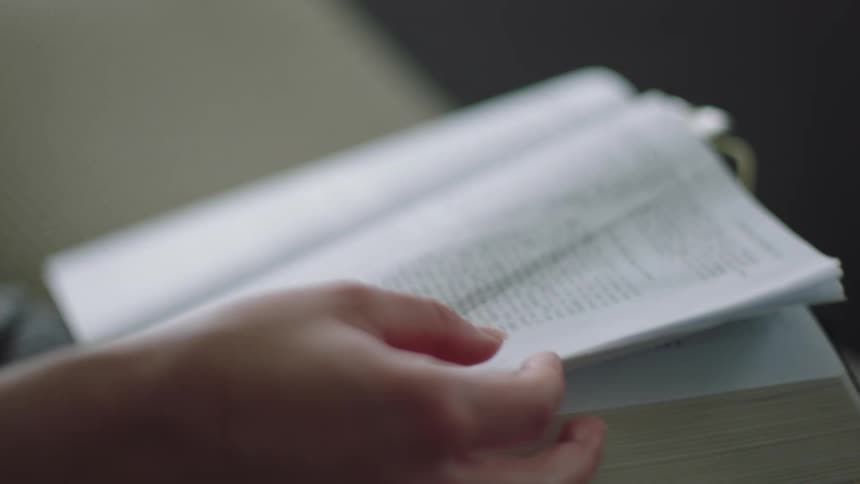 A white person reads a book