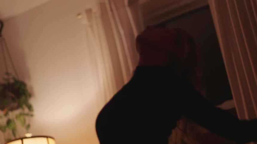 A woman dances in her living room