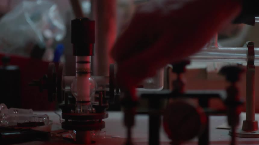 A man turns knobs on equipment