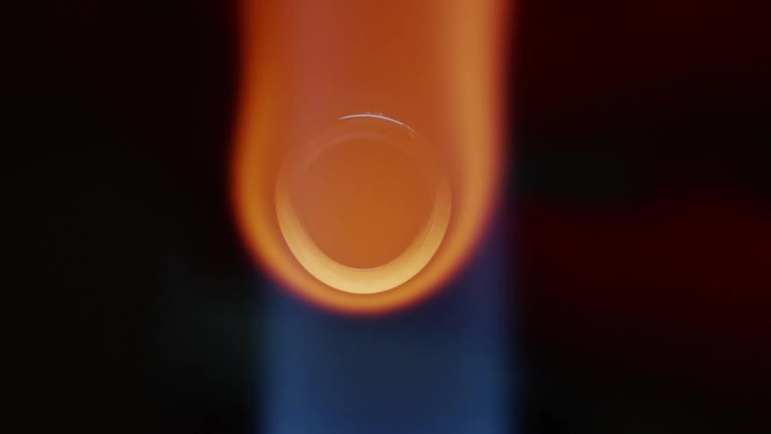 A torch puts off a blue and orange flame