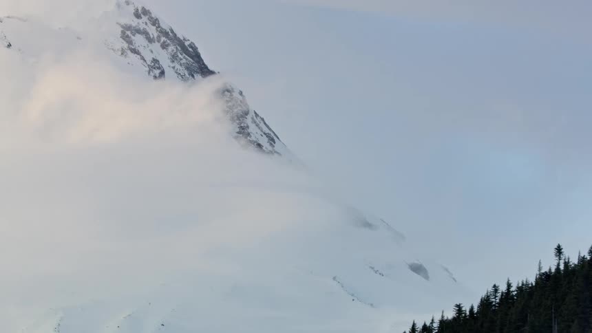 Tight aerial shot looking at super high winds on the flank ridges of Mount Hood in the heart of winter