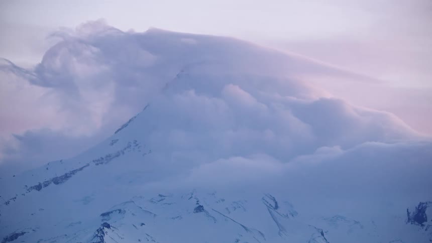 Real time shot of Mount Hood as extreme weather scours the mountain during the heart of winter at sunset