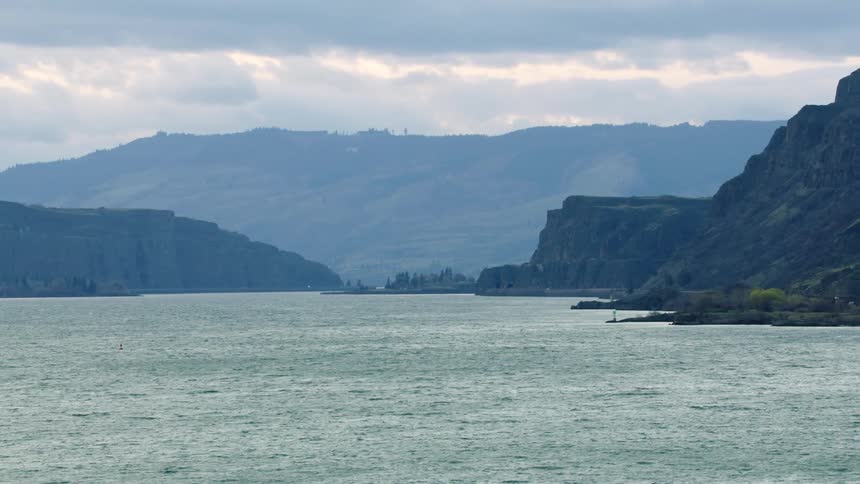 Looking across the vast Columbia River and Columbia River Gorge in late afternoon just as the sun is beginning to set