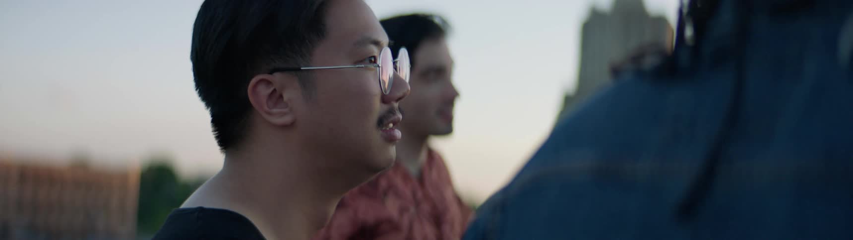 A group of friends nod in agreement at dusk