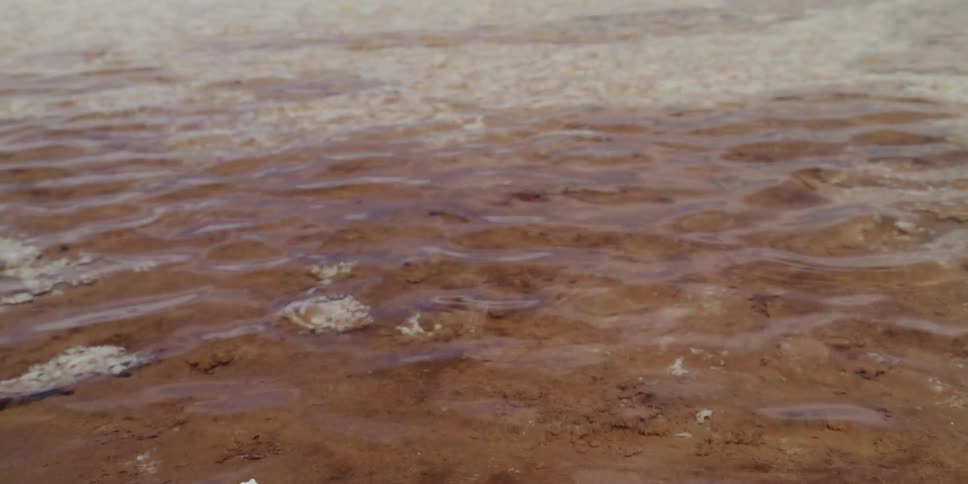 Clear water flows over shallow brownish bed