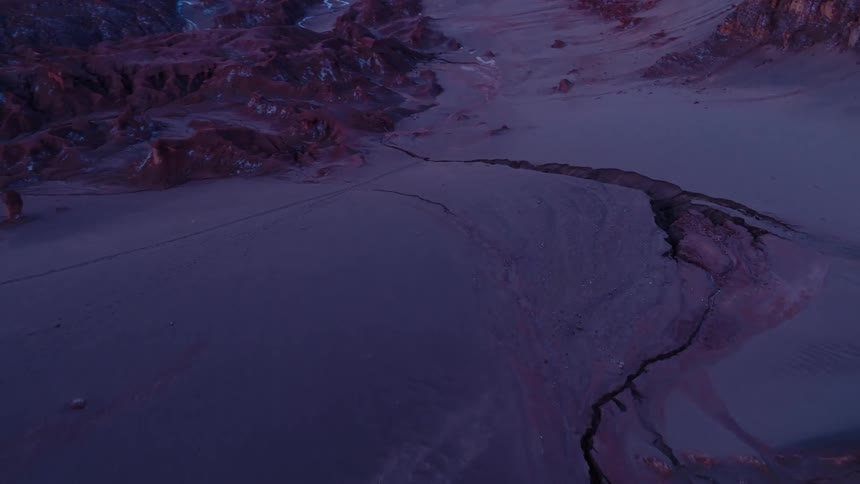 A giant crack cuts across a plain in the badlands