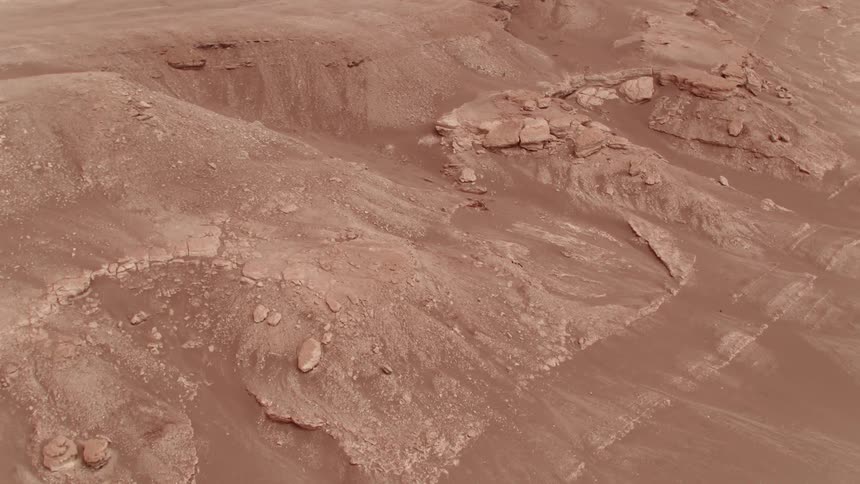 Sand dunes and rocks sit in the desert