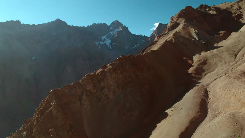 Snow sits on the tallest peaks of a canyon