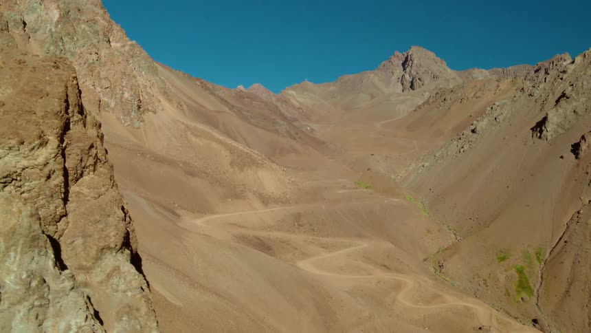 Aerial view of mountains in the desert under a blue sky