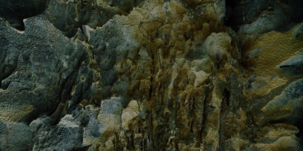 Moss covered rock formations on the side of a mountain