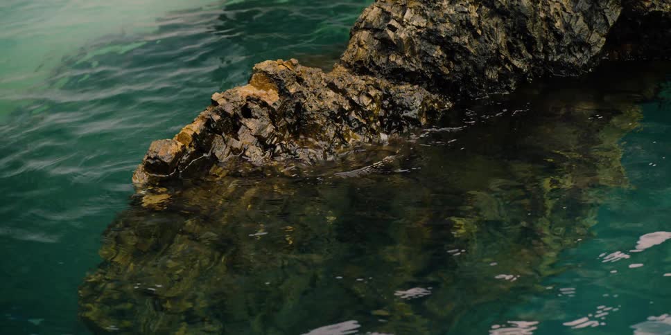 Waves lap against a rocky formation
