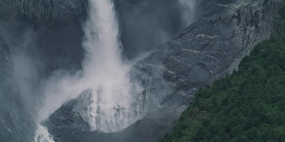 Powerful waterfall crashing down in the canyon in slow motion