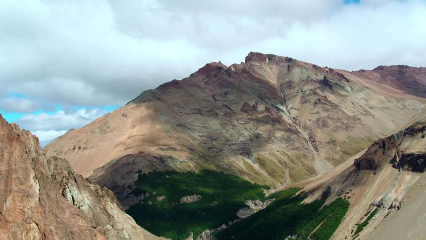Green trees fill a mountain valley