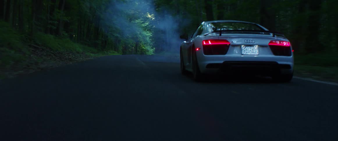 Sports car driving down a foggy highway