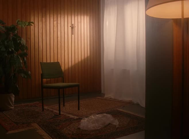 A plastic bag falls and lands in the middle of a living room