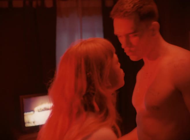 A white man and white woman argue and push in a room