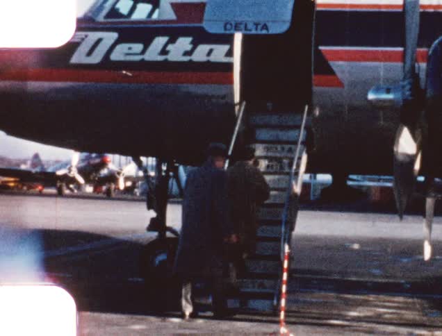 Vintage film of a couple boarding a plane on an airport