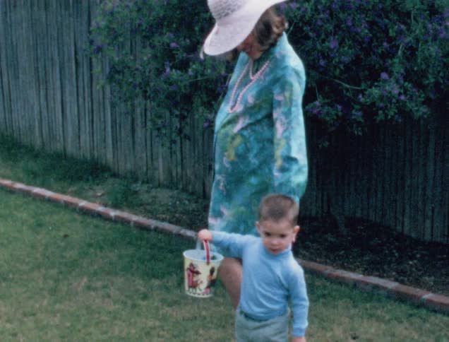 A mother and son are outdoors playing