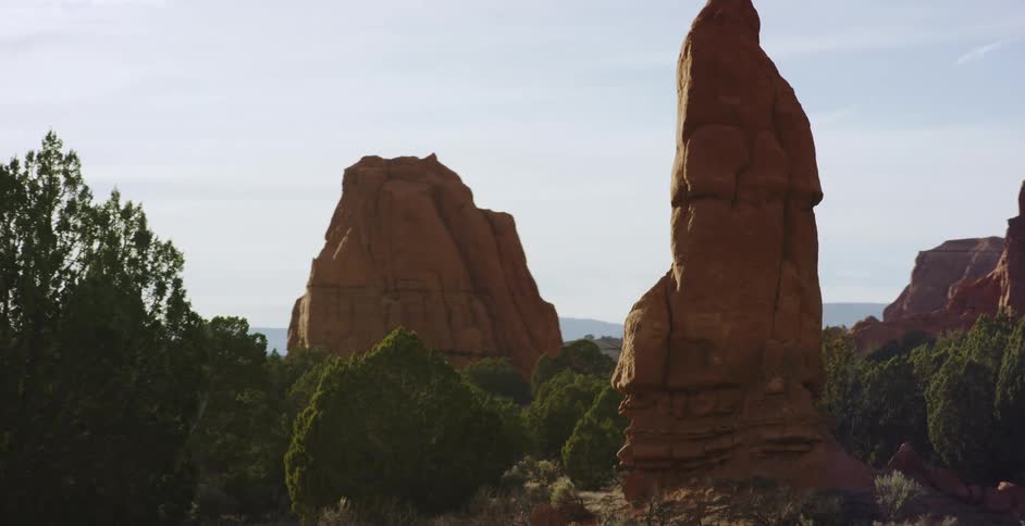 Red rocks and brush cover a landscape