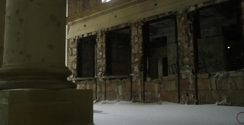 Snow in front of a brick building