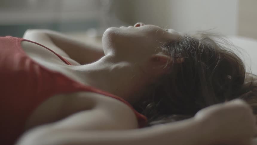 Emotional woman on bed