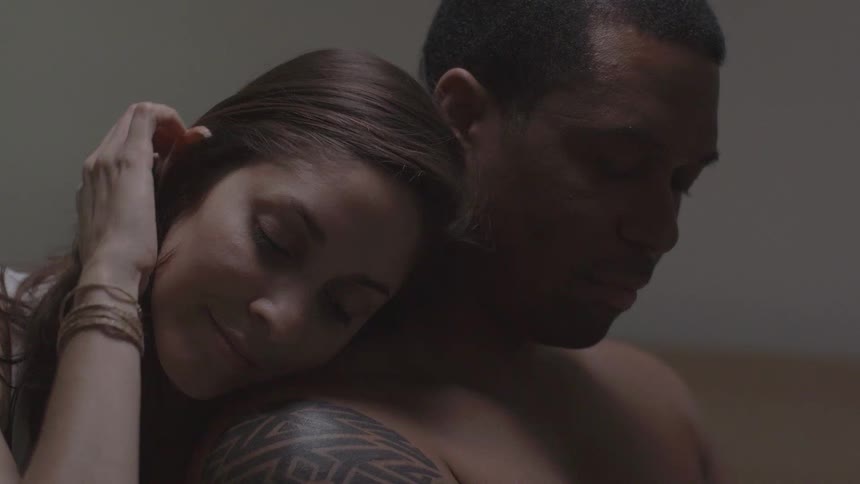 A woman slowly leans and puts her head on a mans shoulder