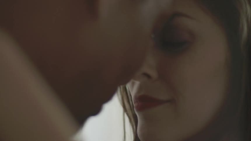 A man and woman are dancing face to face in a room