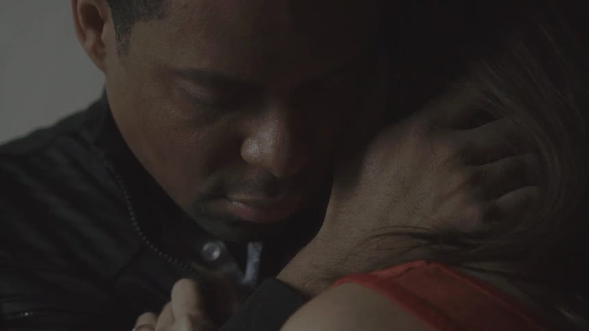 A man holding a woman and caressing her hair