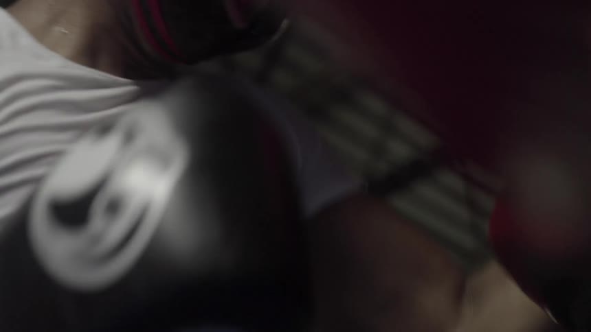 Two boxers are fighting in a ring