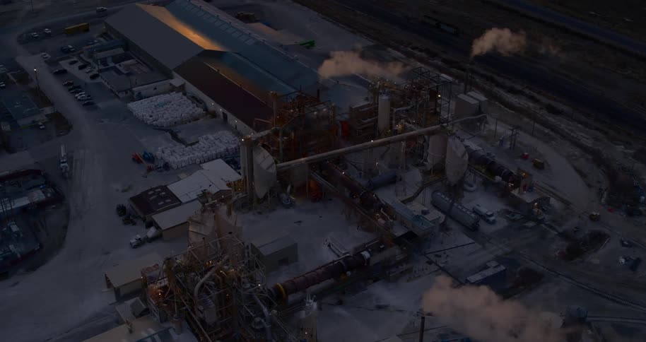 A refinery with chimneys and smoke