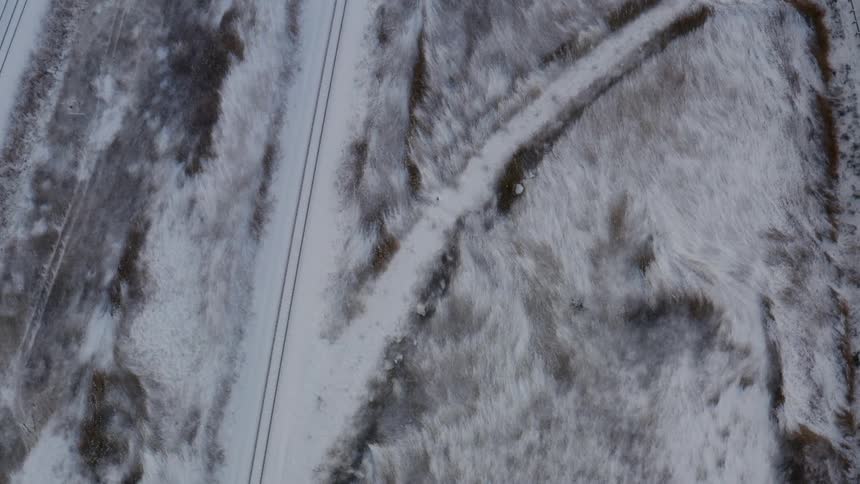 A snow covered road and field