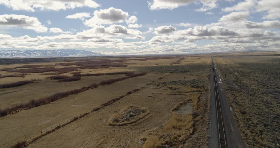 Train tracks run through flat plains