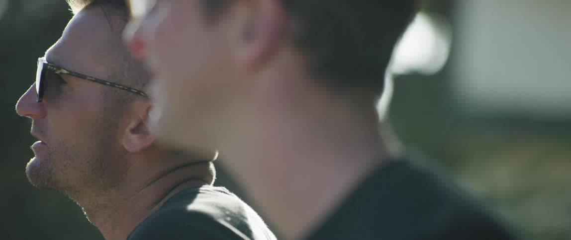 A father and son talking outside