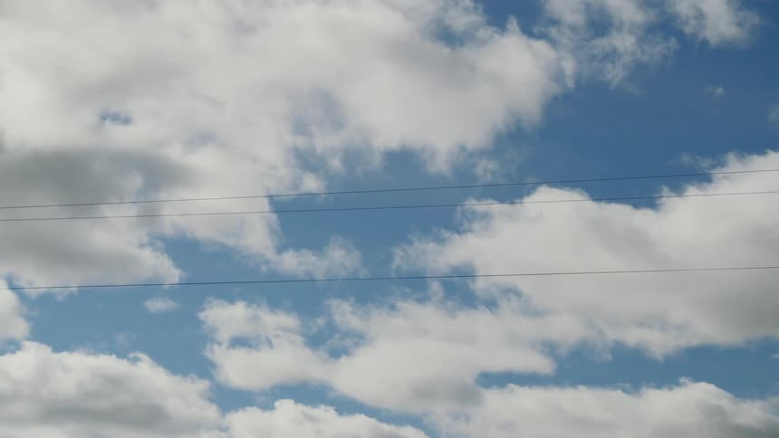 Fluffy clouds fill the sky on a clear day