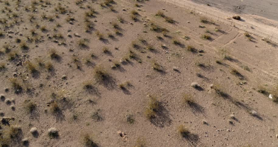 A road next to a fence in the desert