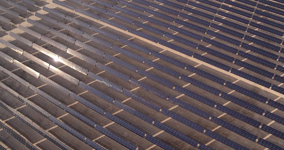 The sun is reflecting off the solar farm