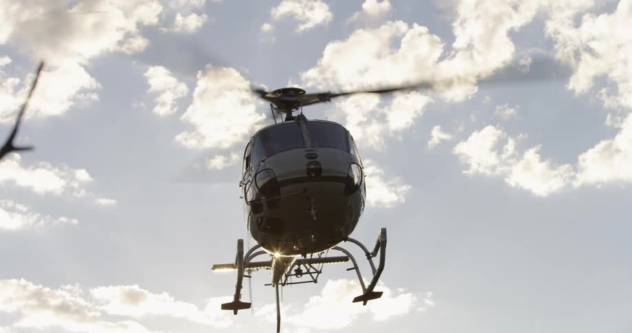 A helicopter hovering with the sky in the background