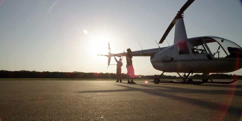 Two men examine a helicopter