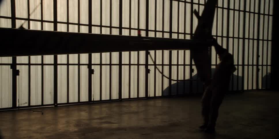 A man moves a helicopter into a hangar by hand