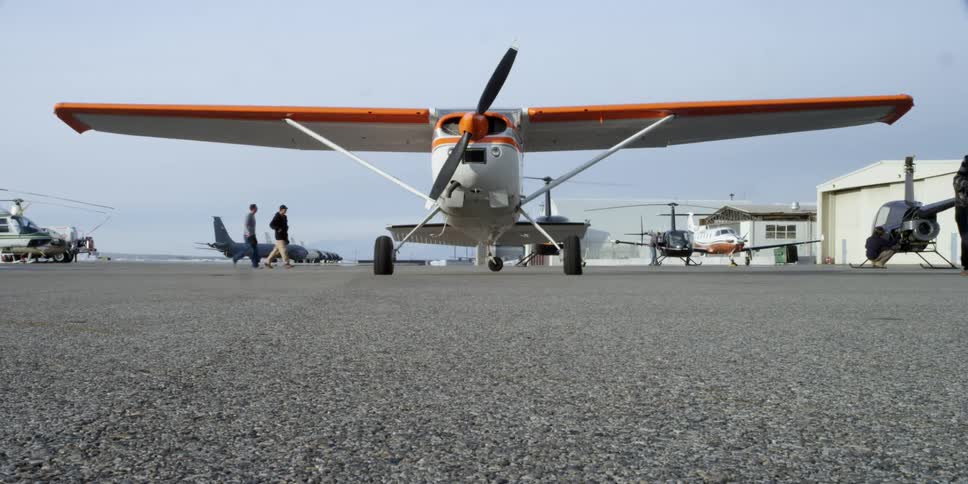 People are walking by a airplane