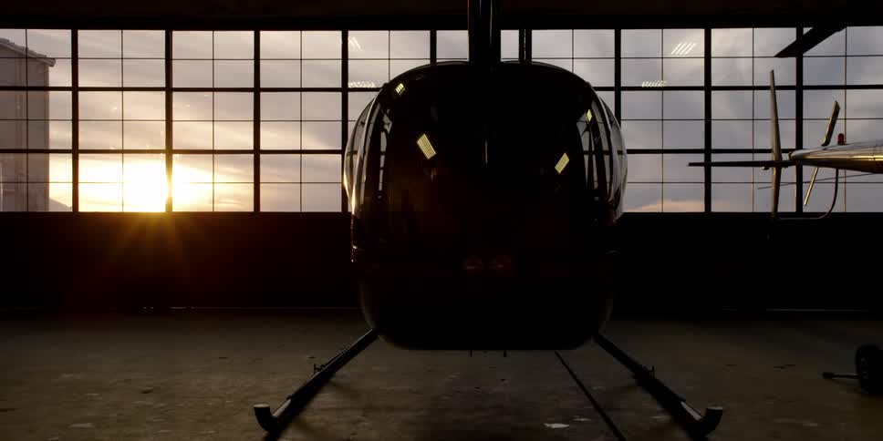 A helicopter is parked inside a hangar