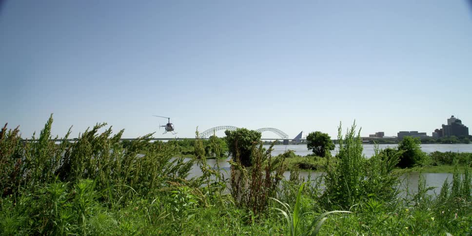 A helicopter flies over a lake