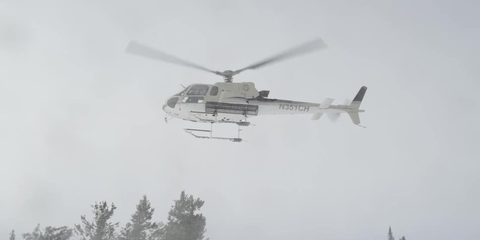 A helicopter rises into the storm