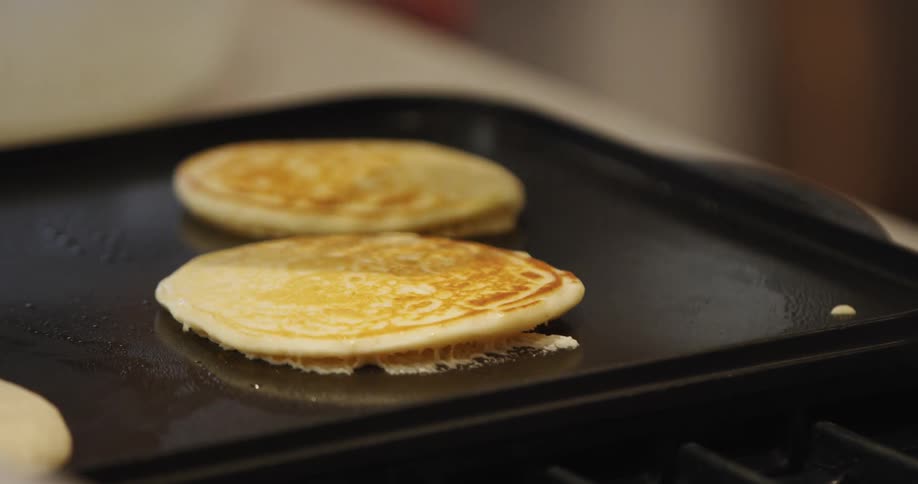 A person flips a pancake with a spatula