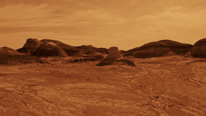 A desert with plateaus and the sky in the background that looks like Mars
