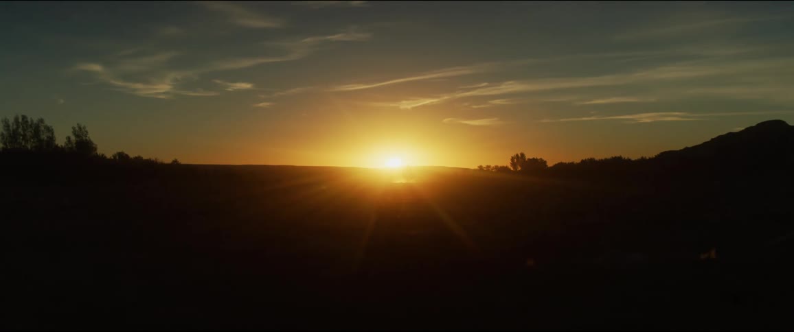 Sun setting over the horizon in the countryside