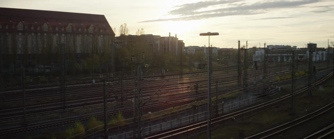 A train station and tracks at dusk